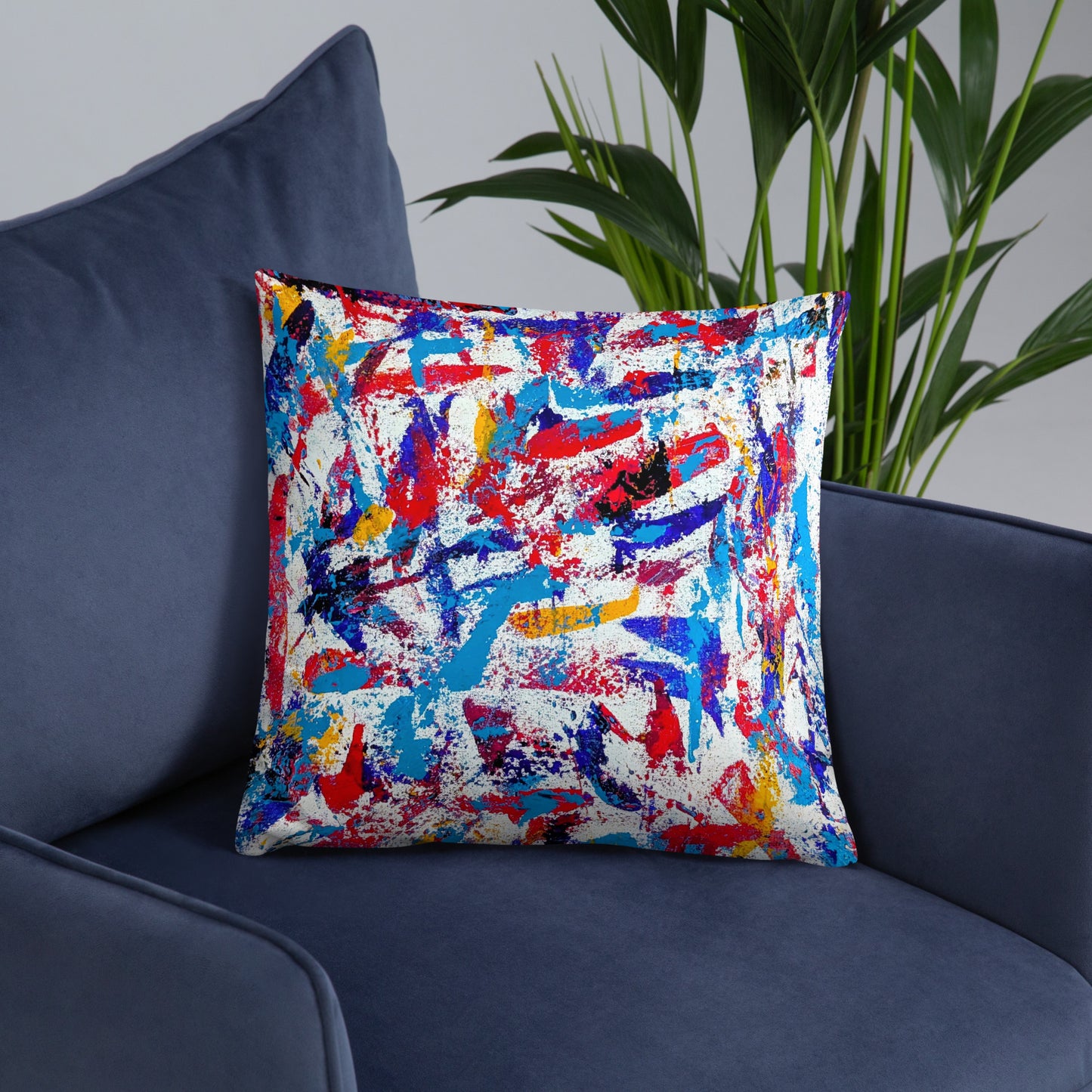 Throw pillow featuring a colorful abstract design, displayed on a neutral chair for a bold modern accent