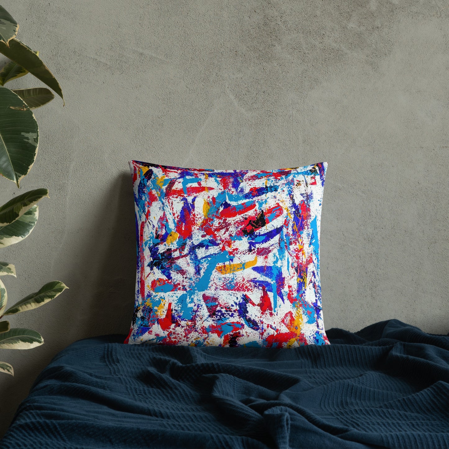 Throw pillow featuring a colorful abstract design, displayed on a neutral bed for a bold modern accent