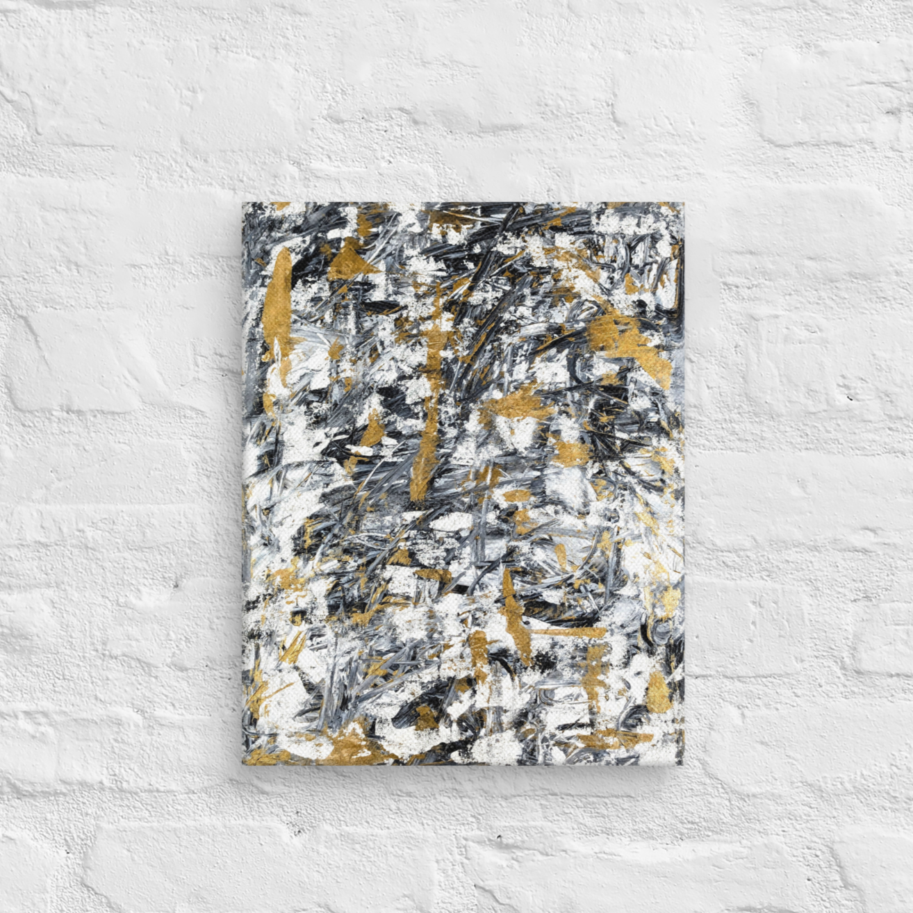 Abstract painting with black, gold, and white on a textured white wall