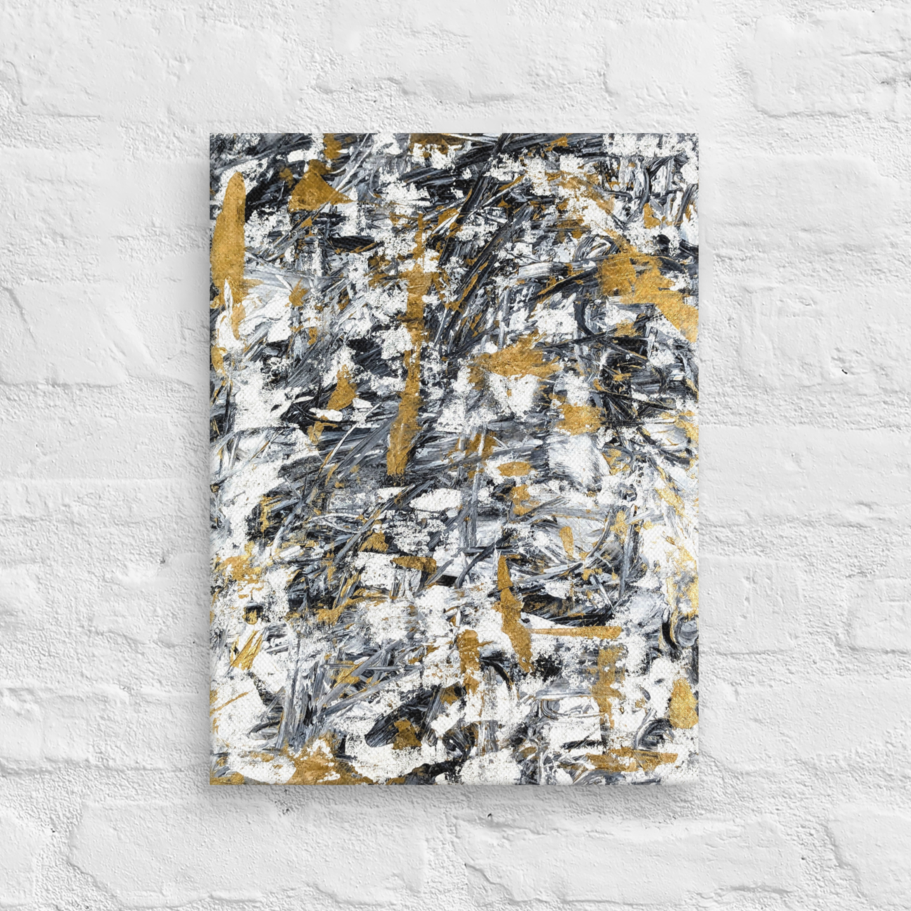 Abstract painting with black, gold, and white on a textured white wall