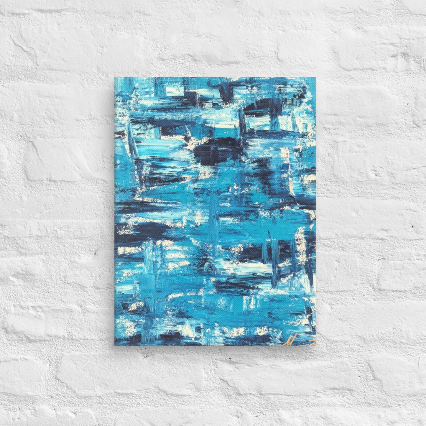 Canvas print of the abstract painting "Blue Streak" with layered blue and white brushstrokes, displayed on a white brick wall in a minimalist interior setting.