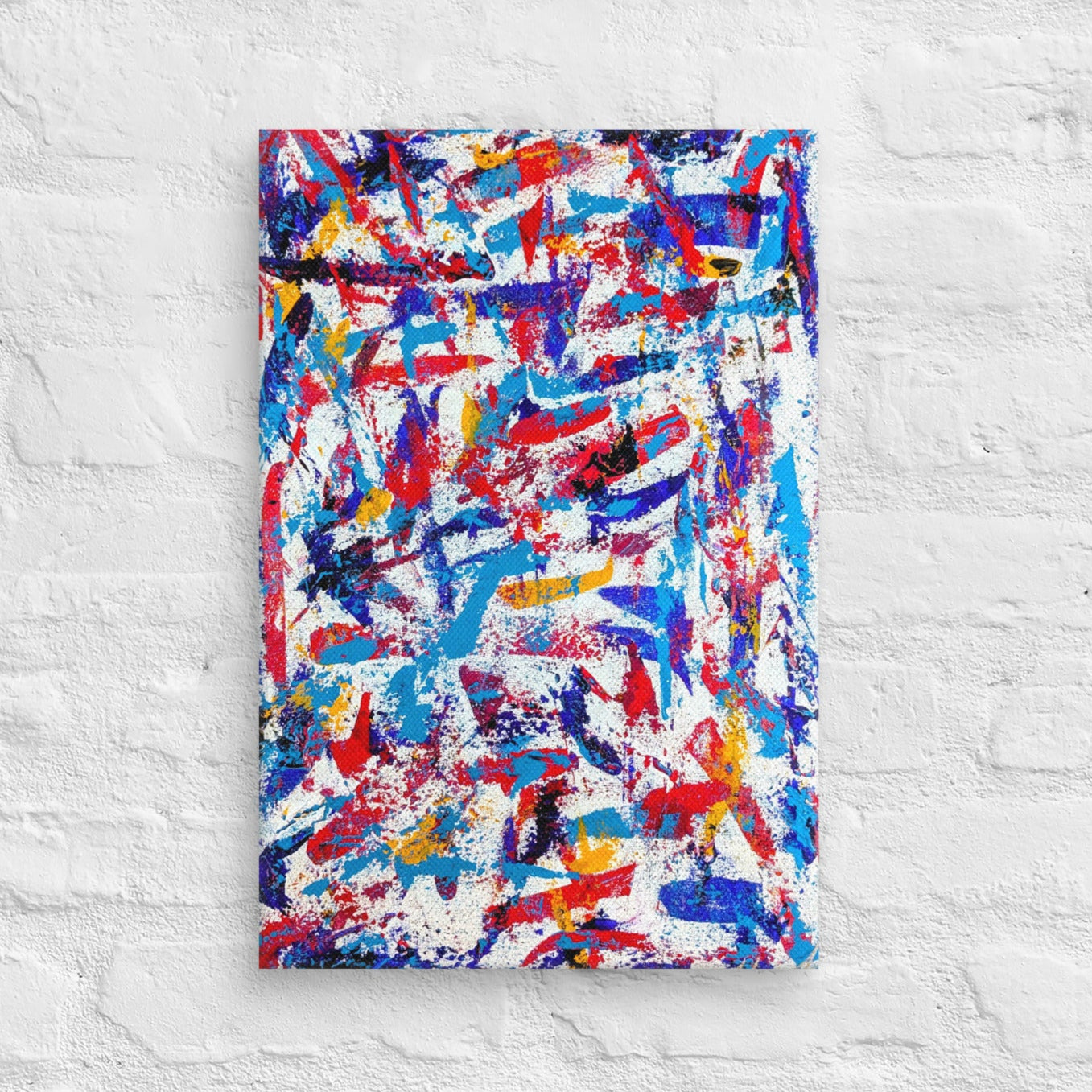 colorful canvas art print mounted on a white brick textured wall, adding vibrant energy to a minimalist interior space