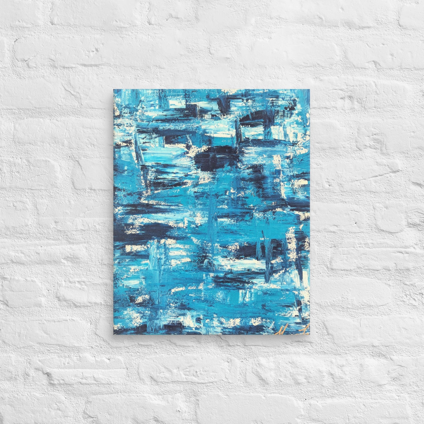 Canvas print of the abstract painting "Blue Streak" with layered blue and white brushstrokes, displayed on a white brick wall in a minimalist interior setting.