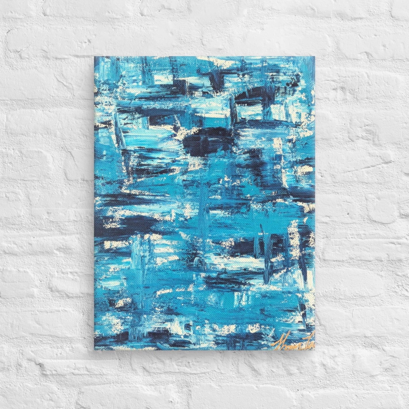 Canvas print of the abstract painting "Blue Streak" with layered blue and white brushstrokes, displayed on a white brick wall in a minimalist interior setting.