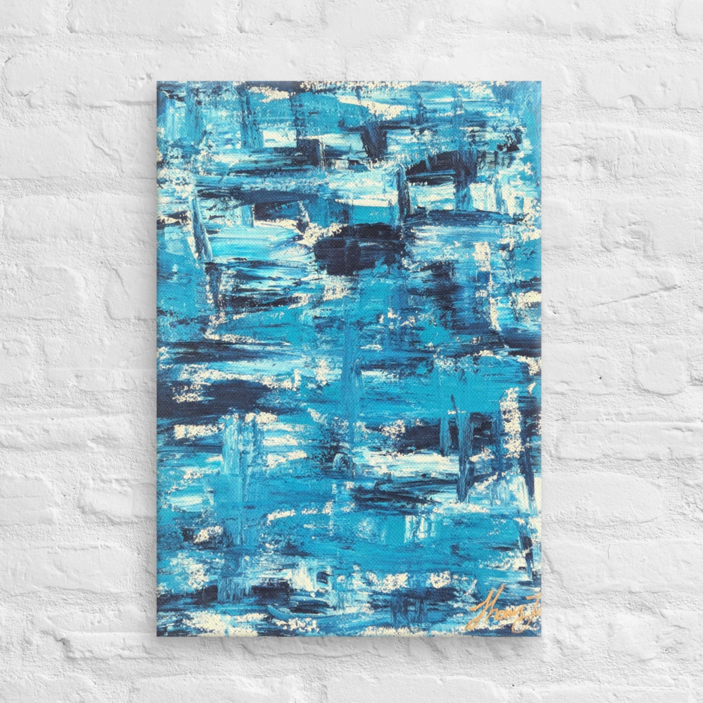 Canvas print of the abstract painting "Blue Streak" with layered blue and white brushstrokes, displayed on a white brick wall in a minimalist interior setting.