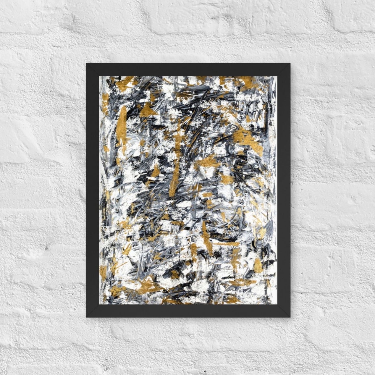 Abstract painting with black, gold, and white on a textured white wall
