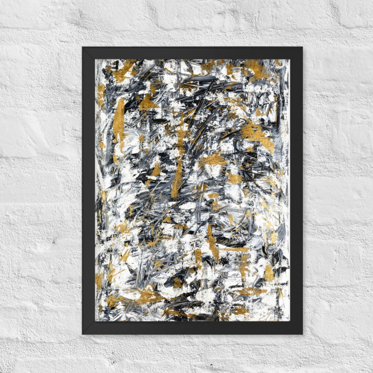 Abstract painting with black, gold, and white on a textured white wall