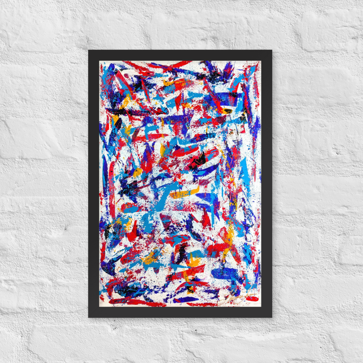 Framed abstract artwork with red, blue, and white colors on a textured white wall.
