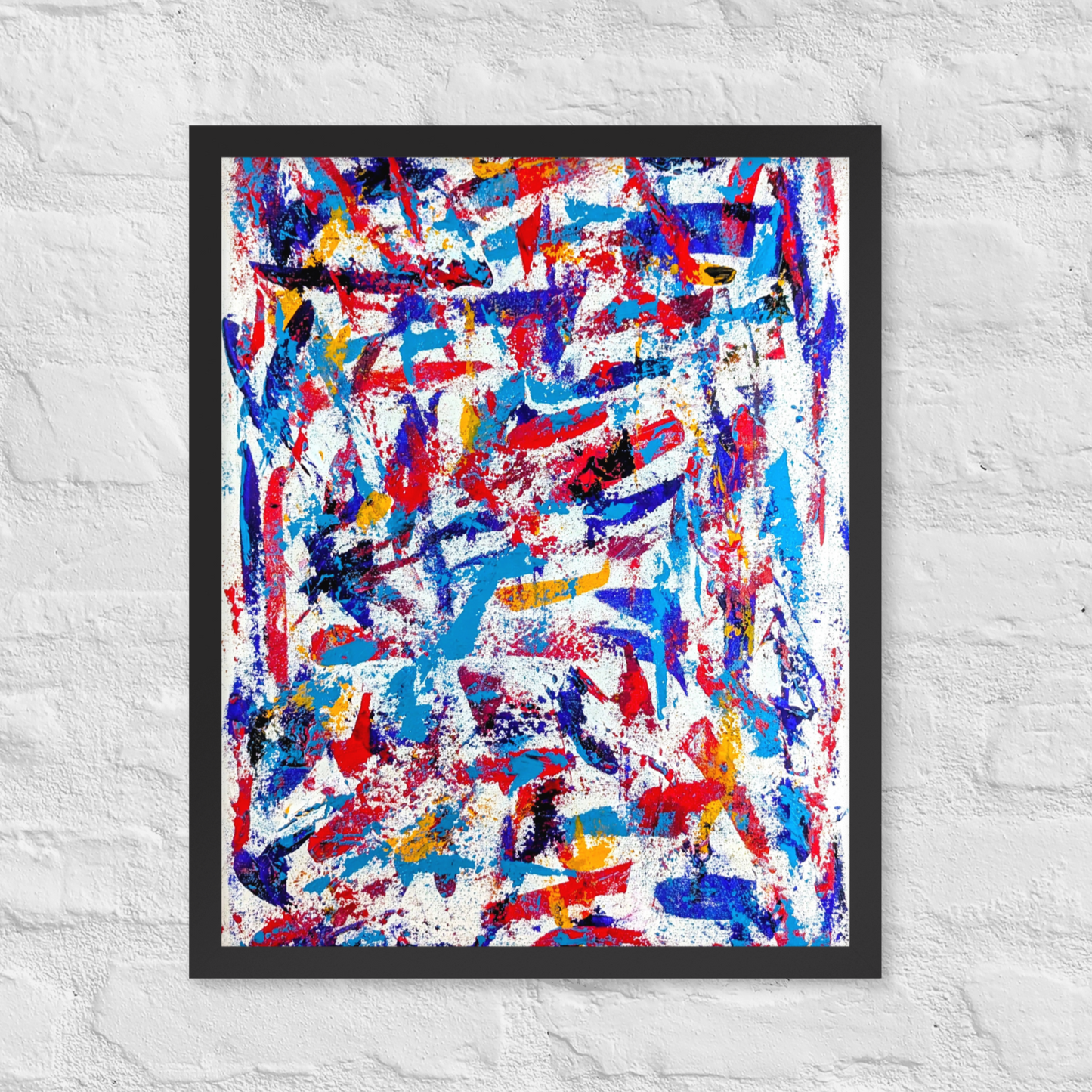 Framed abstract artwork with colorful splashes on a white textured wall