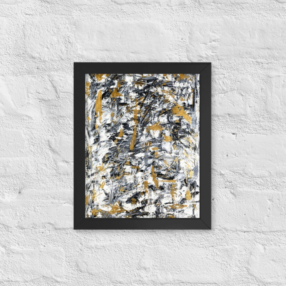 Abstract painting with black, gold, and white on a textured white wall