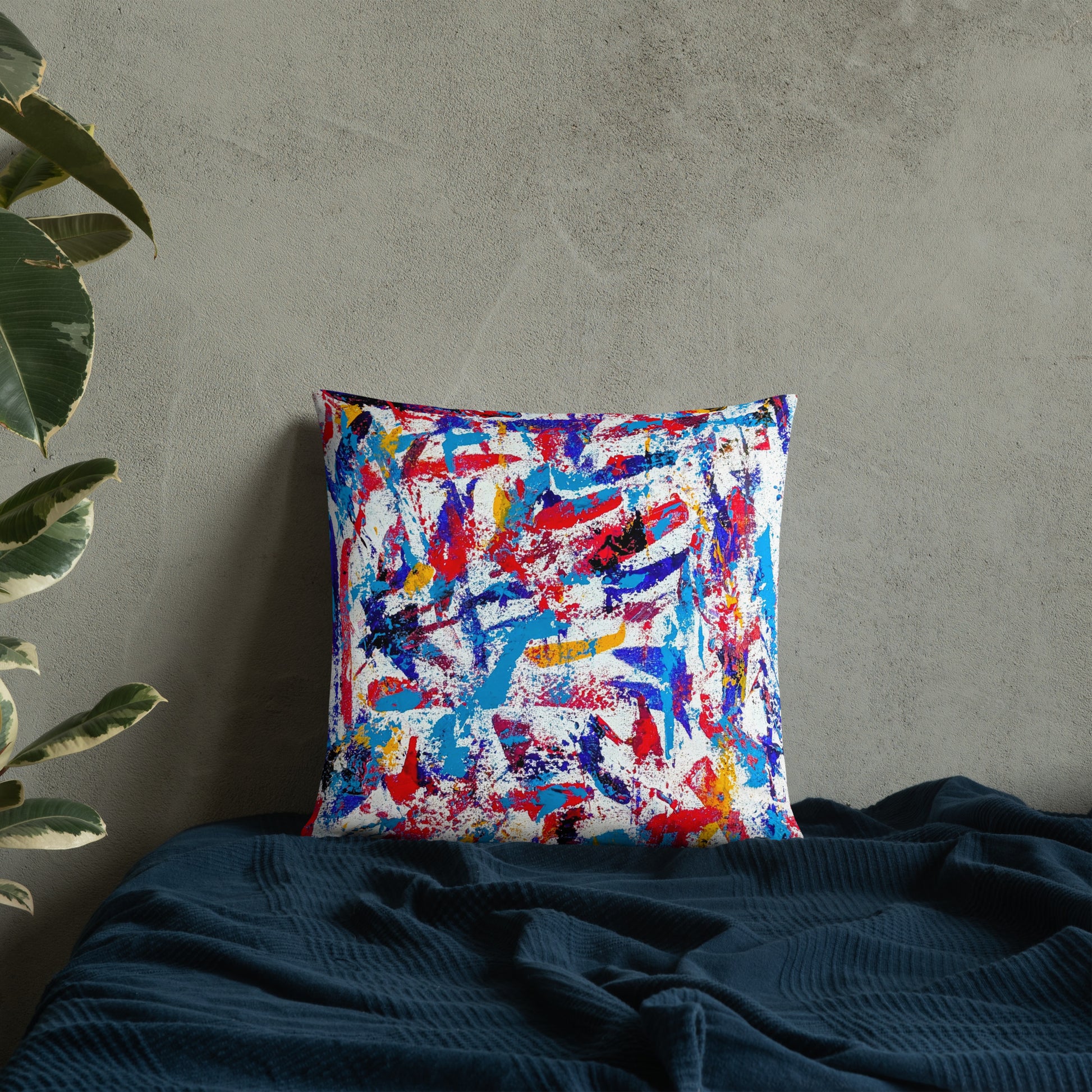 Throw pillow featuring a colorful abstract design, displayed on a neutral bed for a bold modern accent