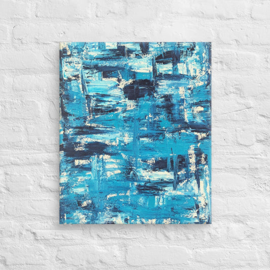 Canvas print of the abstract painting "Blue Streak" with layered blue and white brushstrokes, displayed on a white brick wall in a minimalist interior setting.